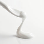 Macro close-up of smooth, white BOTANĒ skincare cream dripping onto a glossy white surface. thumbnail 6